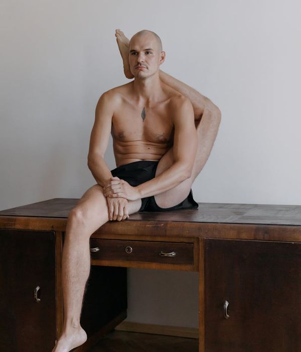 Man performing a controlled strength exercise in a minimalist environment.